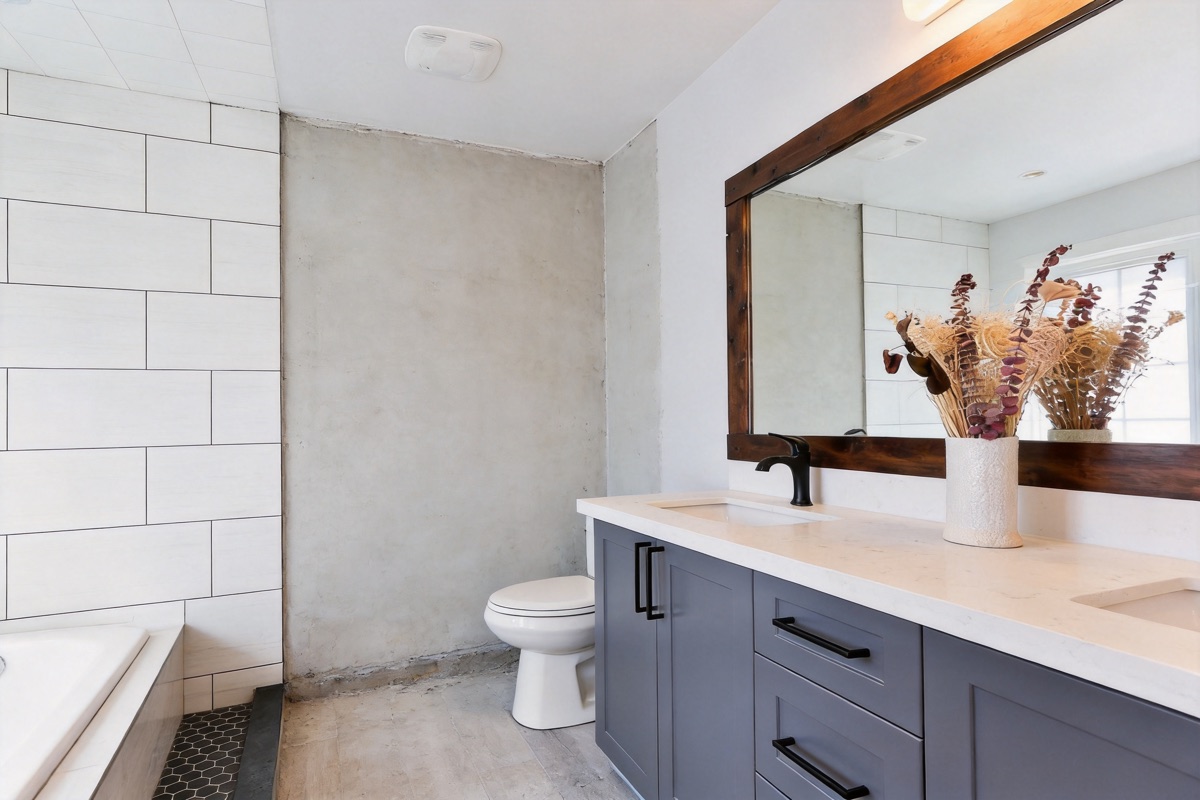Bathroom under construction with unfinished concrete walls and floor