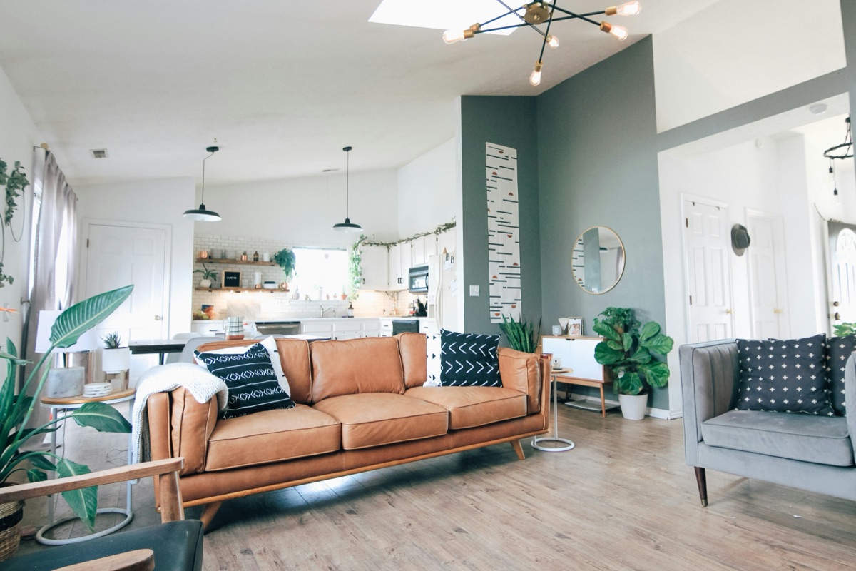 Warm open-plan living room with leather sofa and vaulted ceiling